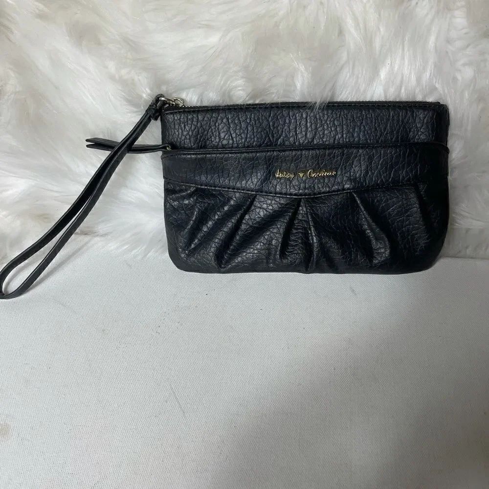 Juicy Couture black wristlet top zipper front zipper with pink lining .